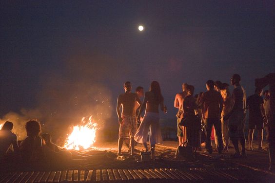 Young people at beach near campfire, sunday party at Sundance Beach Bar, Gennadi beach, Gennadi, Rhodes, Greece